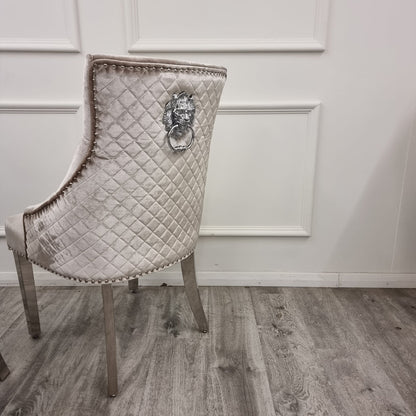 Beige Decorative chair with quilted design and lion head knocker on a wooden floor.