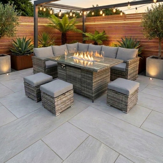 Outdoor patio set with fire pit table on a stone patio