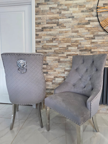 Gray upholstered chairs with decorative elements in a room with a patterned wall.
